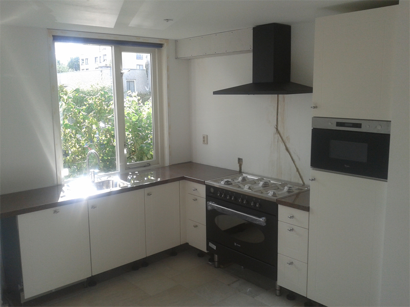 witte keuken met zwarte afzuigkap